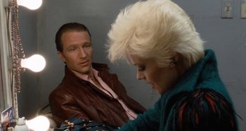 Movie still from “Body Double” (1984), directed by Brian De Palma – A man and a woman are looking at each other; Close Up shot, High angle