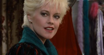 Movie still from “Body Double” (1984), directed by Brian De Palma – A person with blonde hair; Close Up shot, Over the shoulder angle