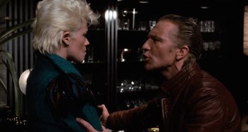 Movie still from “Body Double” (1984), directed by Brian De Palma – A man and a woman are fighting in a bar; Close Up shot, Over the shoulder angle