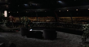 Movie still from “Body Double” (1984), directed by Brian De Palma – A view of a city at night from the top of a building; Extreme Wide shot, High angle
