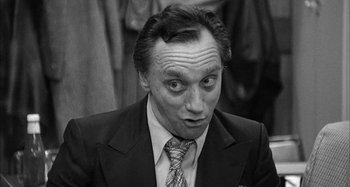 Movie still from “Broadway Danny Rose” (1984), directed by Woody Allen – A man in a suit and tie looking surprised; Close Up shot, High angle