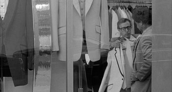 Movie still from “Broadway Danny Rose” (1984), directed by Woody Allen – A man looking at a suit in a store window; Medium shot, Over the shoulder angle