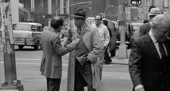 Movie still from “Broadway Danny Rose” (1984), directed by Woody Allen – A man in a hat and a tie is talking to another man in a hat and a tie; Medium shot, Over the shoulder angle