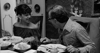 Movie still from “Broadway Danny Rose” (1984), directed by Woody Allen – A man and a woman sitting at a dinner table; Medium shot, Over the shoulder angle