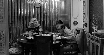 Movie still from “Broadway Danny Rose” (1984), directed by Woody Allen – A man and a woman sitting at a dinner table; Wide shot, Over the shoulder angle