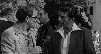 Movie still from “Broadway Danny Rose” (1984), directed by Woody Allen – Two men are talking to each other in a black and white photo; Medium shot, Over the shoulder angle