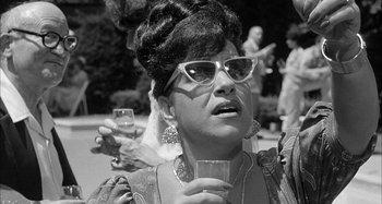 Movie still from “Broadway Danny Rose” (1984), directed by Woody Allen – A woman with a glass of wine in her hand; Close Up shot, Low angle