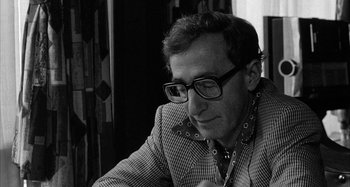 Movie still from “Broadway Danny Rose” (1984), directed by Woody Allen – A black and white photo of a man wearing glasses; Close Up shot, Over the shoulder angle