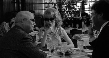 Movie still from “Broadway Danny Rose” (1984), directed by Woody Allen – Two people sitting at a table in a restaurant; Medium shot, Over the shoulder angle