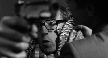 Movie still from “Broadway Danny Rose” (1984), directed by Woody Allen – A black and white photo of a man wearing glasses; Close Up shot, Over the shoulder angle
