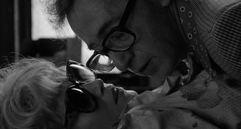 Movie still from “Broadway Danny Rose” (1984), directed by Woody Allen – A black and white photo of a man and a woman kissing; Close Up shot, Overhead angle