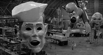 Movie still from “Broadway Danny Rose” (1984), directed by Woody Allen – A black - and - white photo of some giant balloons; Extreme Wide shot, Over the shoulder angle