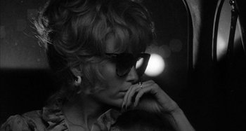 Movie still from “Broadway Danny Rose” (1984), directed by Woody Allen – A black and white photo of a woman wearing sunglasses; Close Up shot, Low angle