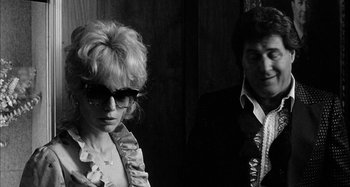 Movie still from “Broadway Danny Rose” (1984), directed by Woody Allen – A man and a woman wearing sunglasses in a room; Close Up shot, Low angle