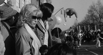 Movie still from “Broadway Danny Rose” (1984), directed by Woody Allen – A woman and a man standing next to each other on a street; Wide shot, Low angle