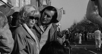 Movie still from “Broadway Danny Rose” (1984), directed by Woody Allen – A man and a woman standing next to each other on the street; Close Up shot, Over the shoulder angle