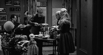 Movie still from “Broadway Danny Rose” (1984), directed by Woody Allen – A black and white photo of a group of people at a table; Wide shot, High angle