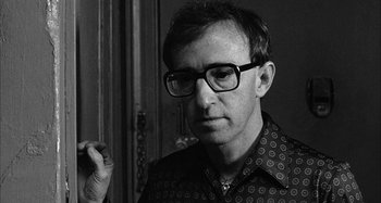 Movie still from “Broadway Danny Rose” (1984), directed by Woody Allen – A black and white photo of a man wearing glasses; Close Up shot, Over the shoulder angle