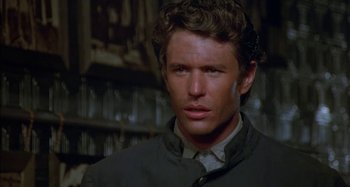 Movie still from “Butch and Sundance: The Early Days” (1979), directed by Richard Lester – A person wearing a jacket; Close Up shot, Over the shoulder angle