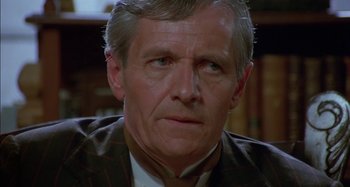 Movie still from “Butch and Sundance: The Early Days” (1979), directed by Richard Lester – An older man in a brown jacket looking at the camera; Close Up shot, High angle