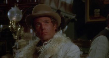 Movie still from “Butch and Sundance: The Early Days” (1979), directed by Richard Lester – A person wearing a hat; Close Up shot, Over the shoulder angle