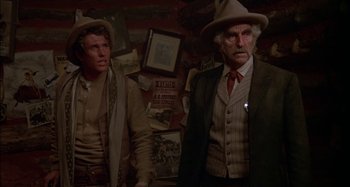 Movie still from “Butch and Sundance: The Early Days” (1979), directed by Richard Lester – Two men standing next to each other in a room; Medium shot, Low angle