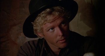 Movie still from “Butch and Sundance: The Early Days” (1979), directed by Richard Lester – A person wearing a hat; Close Up shot, Over the shoulder angle