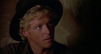 Movie still from “Butch and Sundance: The Early Days” (1979), directed by Richard Lester – A person wearing a hat; Close Up shot, Over the shoulder angle