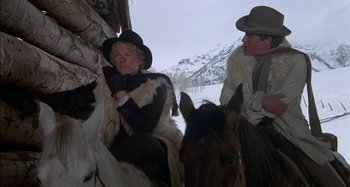 Movie still from “Butch and Sundance: The Early Days” (1979), directed by Richard Lester – Two men sitting on horses in the snow; Medium shot, Low angle