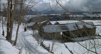 Movie still from “Butch and Sundance: The Early Days” (1979), directed by Richard Lester – A person riding a horse drawn carriage on a snowy day; Extreme Wide shot, High angle