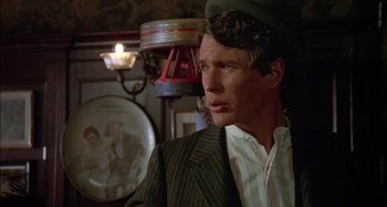 Movie still from “Butch and Sundance: The Early Days” (1979), directed by Richard Lester – A man wearing a suit and hat in front of a mirror; Close Up shot, Over the shoulder angle