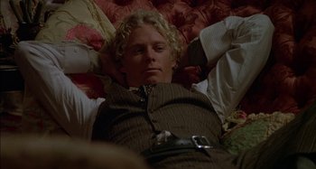 Movie still from “Butch and Sundance: The Early Days” (1979), directed by Richard Lester – A man laying on a bed with his hands behind his head; Medium shot, High angle