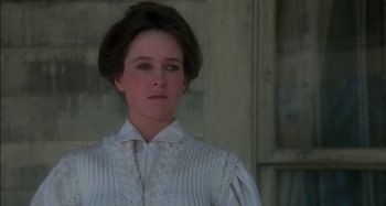 Movie still from “Butch and Sundance: The Early Days” (1979), directed by Richard Lester – A woman in a white shirt and a white sweater; Close Up shot, Over the shoulder angle