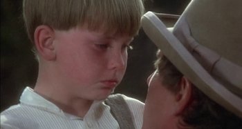 Movie still from “Butch and Sundance: The Early Days” (1979), directed by Richard Lester – A young boy is looking at a young man; Close Up shot, Over the shoulder angle