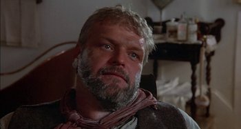 Movie still from “Butch and Sundance: The Early Days” (1979), directed by Richard Lester – A man with a beard and a scarf around his neck; Close Up shot, Low angle