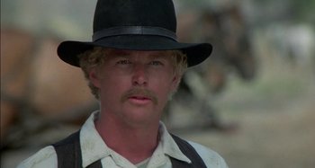 Movie still from “Butch and Sundance: The Early Days” (1979), directed by Richard Lester – A person wearing a hat; Close Up shot, Over the shoulder angle