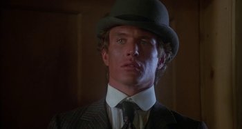 Movie still from “Butch and Sundance: The Early Days” (1979), directed by Richard Lester – A person wearing a suit and a hat; Close Up shot, Low angle