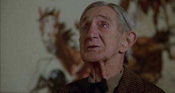Movie still from “Butch and Sundance: The Early Days” (1979), directed by Richard Lester – An old man with a long gray hair looking up at the ceiling; Close Up shot, Low angle