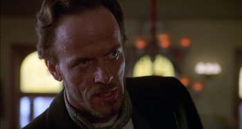 Movie still from “Butch and Sundance: The Early Days” (1979), directed by Richard Lester – A person wearing a suit and tie; Close Up shot, Low angle