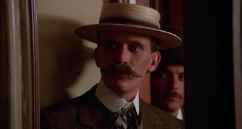 Movie still from “Butch and Sundance: The Early Days” (1979), directed by Richard Lester – A person wearing a hat and a tie; Close Up shot, Low angle