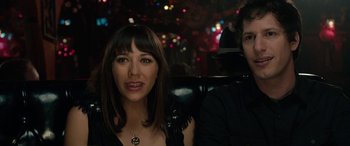 Movie still from “Celeste & Jesse Forever” (2012), directed by Lee Toland Krieger – A woman sitting next to a man in front of a crowd; Close Up shot, Over the shoulder angle