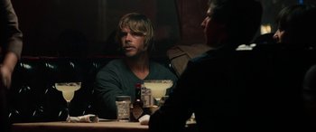 Movie still from “Celeste & Jesse Forever” (2012), directed by Lee Toland Krieger – A man sitting at a table in front of another man; Medium shot, Over the shoulder angle