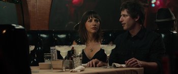 Movie still from “Celeste & Jesse Forever” (2012), directed by Lee Toland Krieger – A woman sitting at a table with two men; Medium shot, Over the shoulder angle