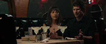 Movie still from “Celeste & Jesse Forever” (2012), directed by Lee Toland Krieger – A woman sitting at a table with two men; Close Up shot, Over the shoulder angle