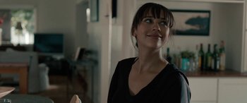 Movie still from “Celeste & Jesse Forever” (2012), directed by Lee Toland Krieger – A woman in a black shirt is looking up at the ceiling; Close Up shot, Over the shoulder angle