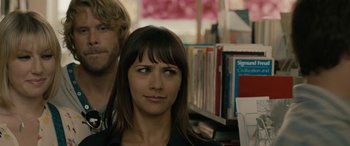 Movie still from “Celeste & Jesse Forever” (2012), directed by Lee Toland Krieger – A woman standing next to a man in front of a book shelf; Close Up shot, Over the shoulder angle