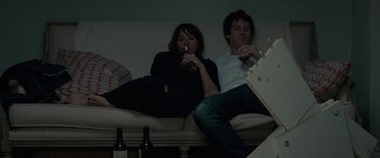 Movie still from “Celeste & Jesse Forever” (2012), directed by Lee Toland Krieger – A man and a woman sitting on a couch drinking wine; Medium shot, High angle