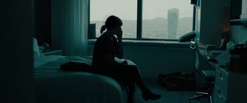 Movie still from “Celeste & Jesse Forever” (2012), directed by Lee Toland Krieger – A woman sitting on a bed in front of a large window; Medium shot, High angle