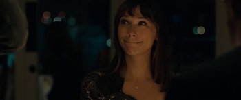 Movie still from “Celeste & Jesse Forever” (2012), directed by Lee Toland Krieger – A beautiful woman with long brown hair wearing a black dress; Close Up shot, Over the shoulder angle