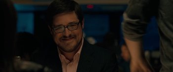 Movie still from “Celeste & Jesse Forever” (2012), directed by Lee Toland Krieger – A person wearing glasses and a suit; Close Up shot, Over the shoulder angle